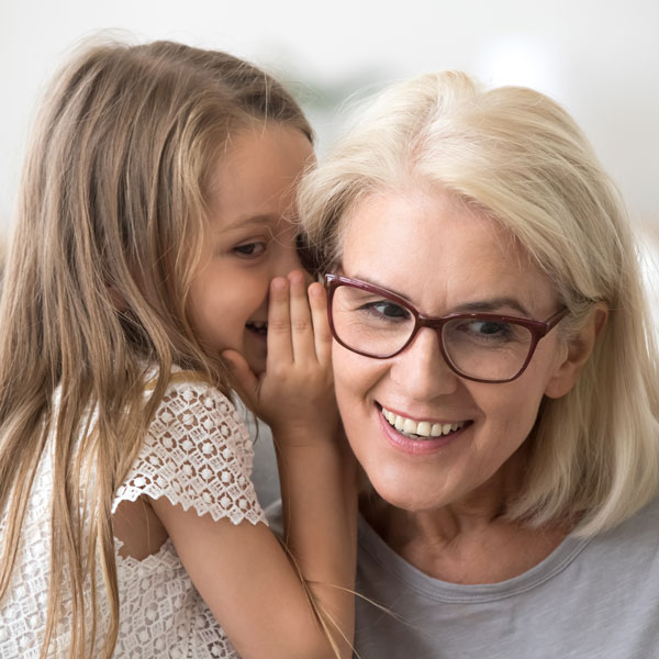 Child Whispers to a Woman After Her Hearing Evaluation in Castle Rock, CO