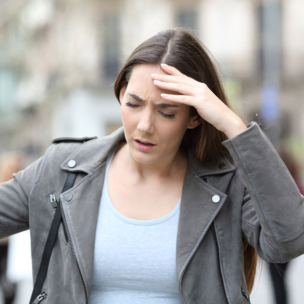 A Woman Holding Her Forehead, Representing Dizziness in Castle Rock, CO