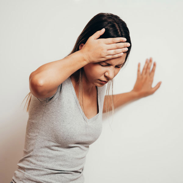 A Young Woman Is Experiencing Dizziness Due to an Ear-Related Condition in Castle Rock, CO.