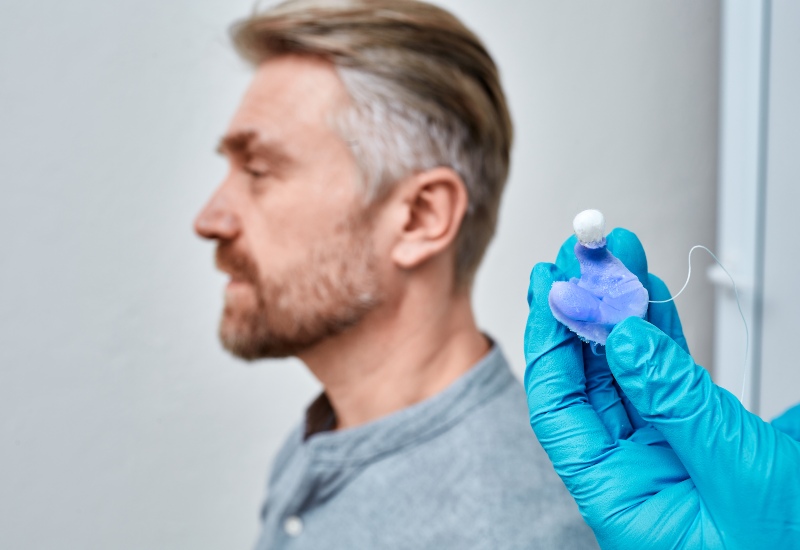 Audiologist Holding Molded Individual Earmolds for Hearing Aids in Castle Rock, CO