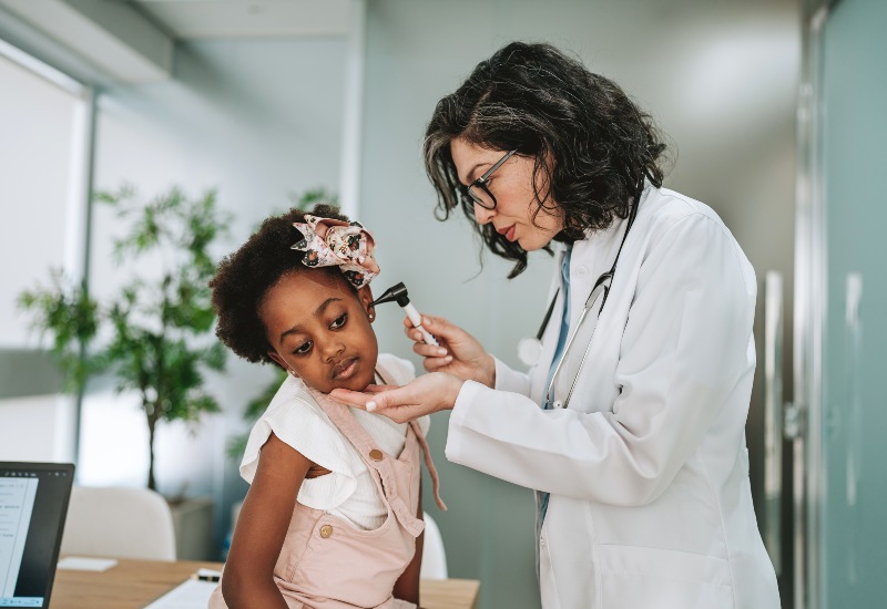 Audiologist Examining a Child's Ear for Pediatric Hearing Loss in Castle Rock, CO