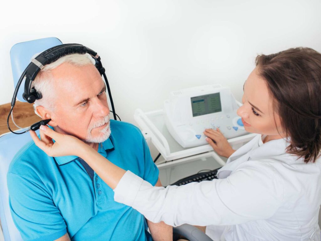 Professional audiologist performing hearing test in Castle Rock, CO